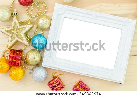 Vintage white blank photo frame with christmas decorations on wood background. Save clipping path.