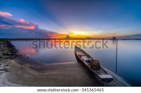 The boat speeding toward the sun as if to hold back the light at sunset like A arrow shooting in the sky sunset. This picture was taken in Pha Tam Giang Lagoon, famous lagoon in Hue, Viet Nam ,Travel