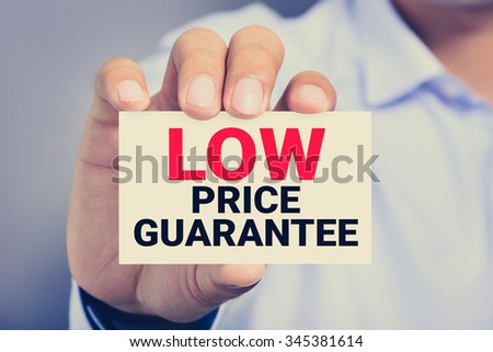 LOW PRICE GUARANTEE, message on the card shown by a man, vintage tone