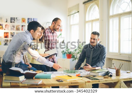 Start up business. Group of young architect at office Royalty-Free Stock Photo #345402329
