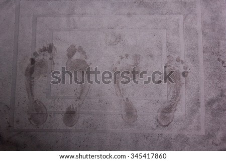 footsteps on a bathmat Royalty-Free Stock Photo #345417860
