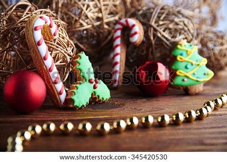 Christmas mood still life with gingerbread mistletoe and christmas lolly pop, tree with red christmas balls and gold decoration. With copy space. 