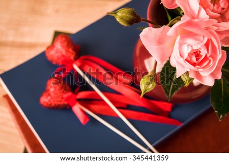 Pink rose on wooden table background with retro glasses and white hand made paper as a copy space, Romantic floral theme