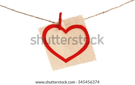 Paper heart and empty sheet hang on cord isolated on white background