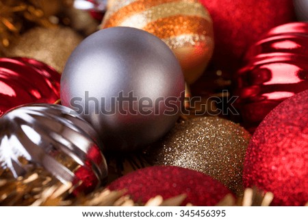 christmas balls in gold, red and silver stacked as background for xmas party / Christmas balls decorative for christmas holiday background