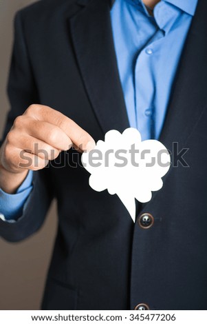 hand holding a cloud of thoughts. advertising or business concept, isolated on a gray background.