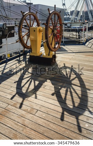 The ship's wheel and its shadow.