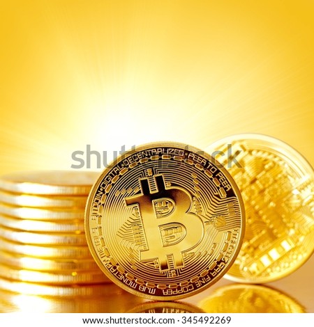 Golden Bitcoins on a gold background .Photo (new virtual money ) Background with a copy-space .