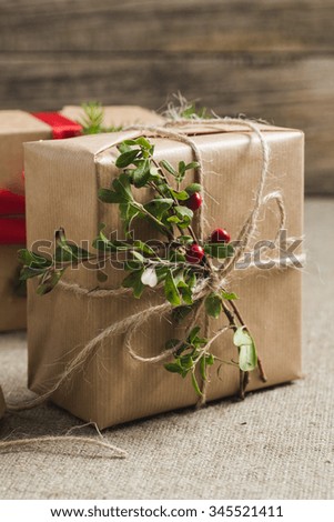 Handmade christmas or New Year gifts on wooden background.