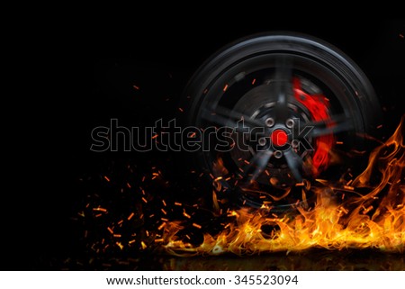 Drifting and fire smoking sport car tire with red breaks isolated on a black background  Royalty-Free Stock Photo #345523094