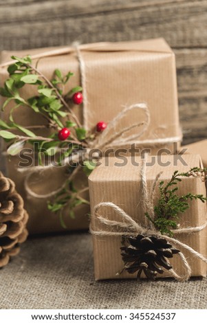 Handmade christmas or New Year gifts on wooden background.