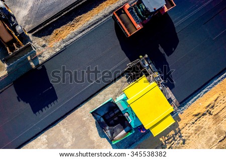 Aerial view on the new asphalt road under construction Royalty-Free Stock Photo #345538382