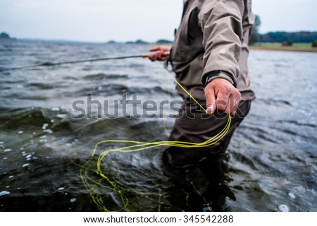 Fly fishing taking line Royalty-Free Stock Photo #345542288