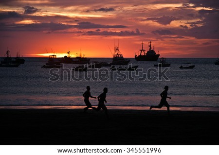Kids playing in the beach at sunset time, San Juan del Sur, Nicaragua Royalty-Free Stock Photo #345551996