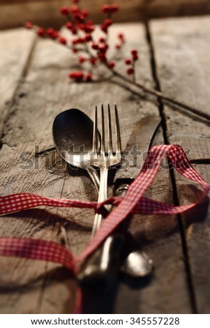 Christmas table place setting with christmas pine branches,ribbon and bow. Christmas holidays background
