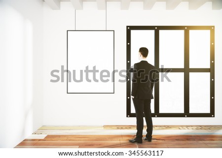 Blank poster on white wall in empty room with wooden floor and businessman, mock up 3D Render