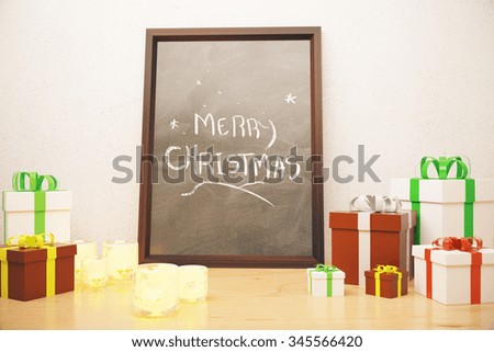 Picture frame with Merry Christmas lettering and gift boxes at white background