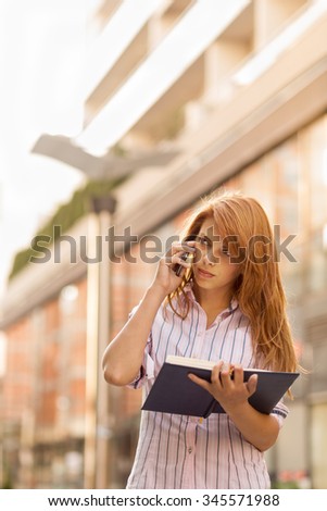 Modern business woman having a phone conversation with a colleague