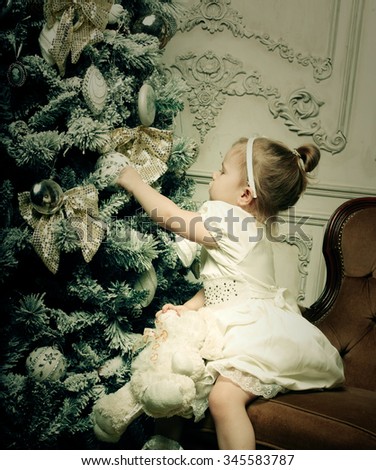 little girl near cristmass tree, holiday picture