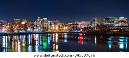 Wilmington skyline panorama reflected in Christiana River. Wilmington, the largest city in the state of Delaware, is built on the site of Fort Christina, the first Swedish settlement in North America Royalty-Free Stock Photo #345587876