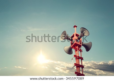 Horn speaker for public relations sign symbol, vintage color - sun with blue sky Royalty-Free Stock Photo #345597089