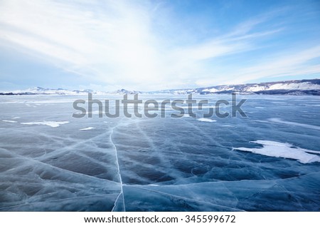 Winter ice landscape on Siberian lake Baikal with dramatic weather clouds front before the Storm Royalty-Free Stock Photo #345599672