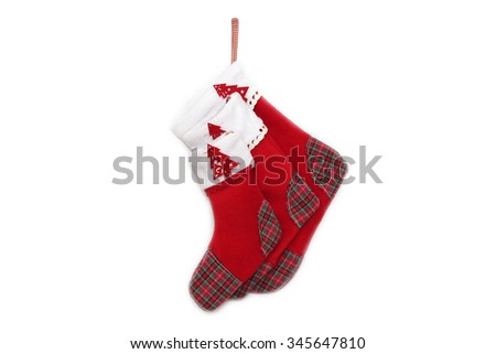 Three red Christmas socks with tree decor for Santa gifts lying on each other on white background, winter holidays symbol