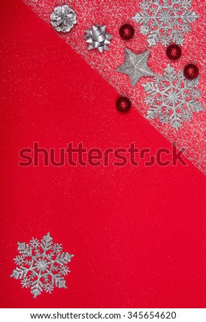 Christmas decoration background over red background. Photo taken from above, top view with copy space for text or other design elements.