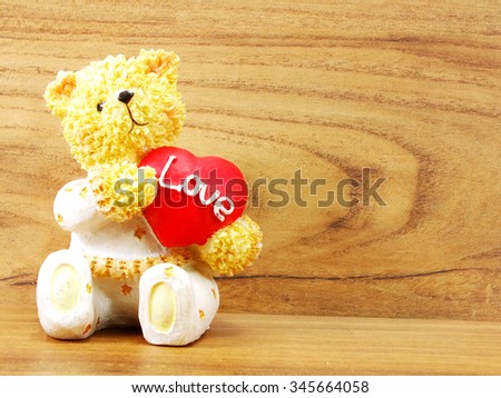 teddy bear doll holding heart shaped with love