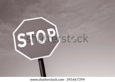 Stop Traffic Sign on Sky Background in Black and White Sepia Tone