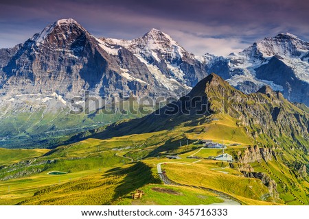 Stunning alpine panorama with Jungfrau,Monch,Eiger North face and Mannlichen cable car station,Grindelwald,Bernese Oberland,Switzerland,Europe Royalty-Free Stock Photo #345716333