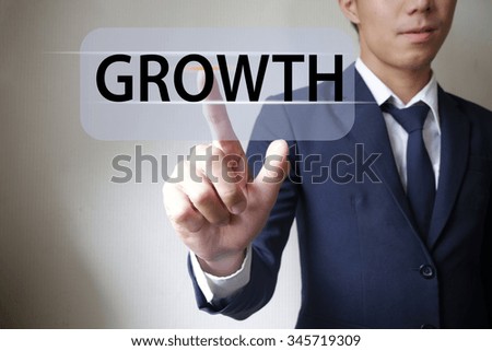 Business man pressing growth button , business concept 