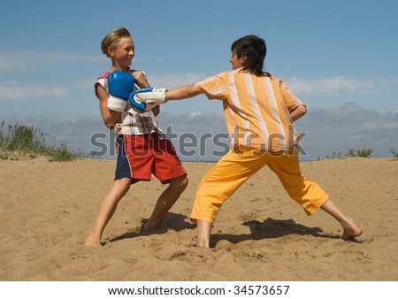 The teens on golden sea sand (wrestle)