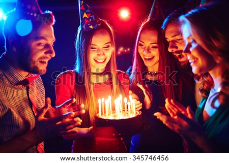 Happy young friends celebrating birthday