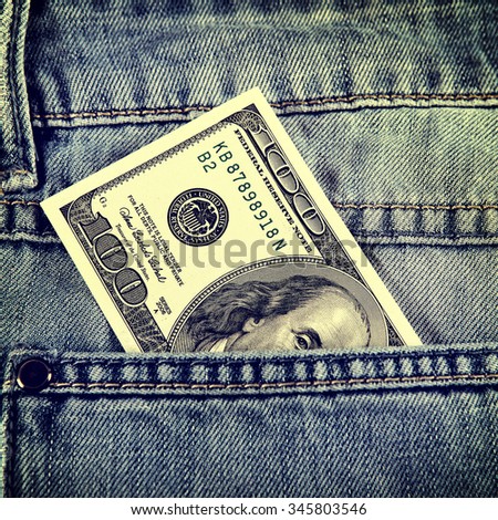 Toned Photo of Hundred Dollars in the Pocket of the Jeans closeup