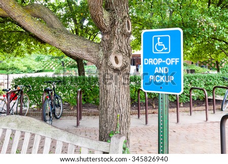 Handicapped parking sign for disabled drivers and wheelchair space.