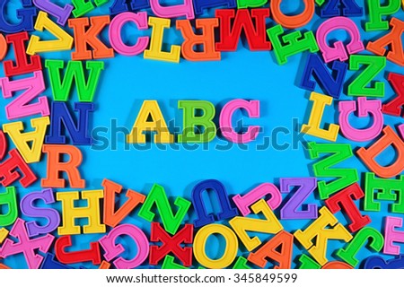 Plastic colored alphabet letters ABC on a blue background 