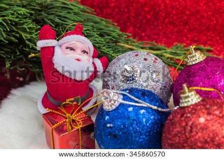 Holiday Christmas ball and santa red background with gift boxes