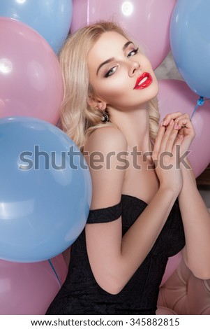 Woman and Gifts. Girl with joy on her face, beautiful picture stylish, trendy makeup on his face, the balls in the background. Head of a Woman  