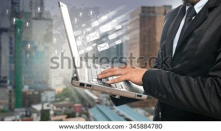 Businessman using the laptop computer on the abstract Blurred photo of sky train with cityscape