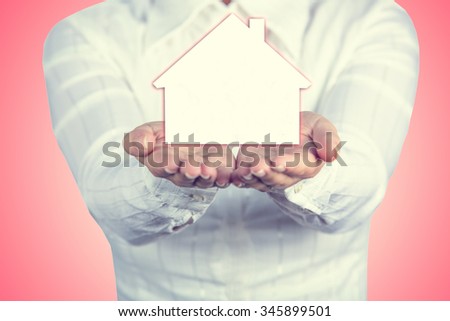 Propriety insurance concept ,Woman holding hands with a drawn family symbol.Family life insurance, family services, family policy concept.