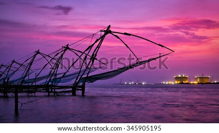 Panorama of tourist attraction of Kochi - chinese fishnets on sunset. Fort Kochin, Kochi, Kerala, India Royalty-Free Stock Photo #345905195