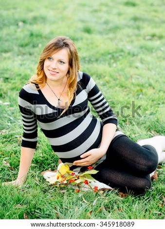 Beautiful pregnant woman outdoors