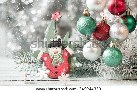 Christmas background with decorations on wooden board. Soft focus.