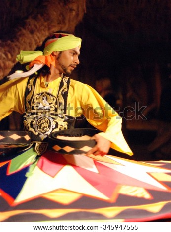 Egyptian man is dancing oriental dance Royalty-Free Stock Photo #345947555