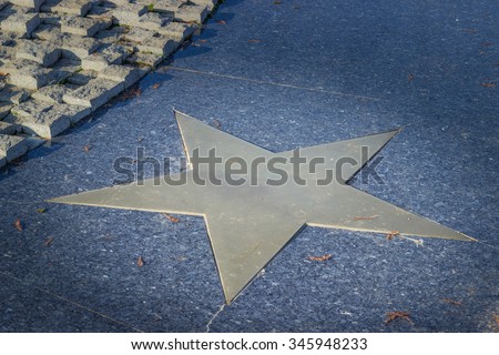 Bronze star in marble pavement Close-up horizontal view