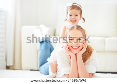 Happy loving family. mother and child girl playing lying on the floor at home