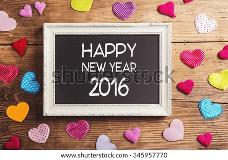 Happy new year composition. Studio shot on wooden background.