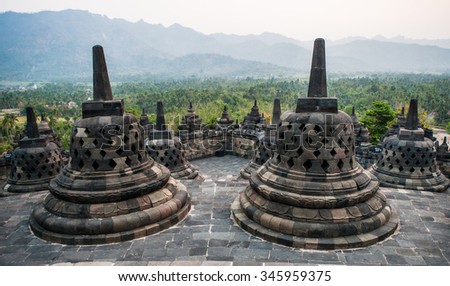 Stone stupa on the background of the surrounding landscape. Borobudur. Indonesia. The island of Java. An excellent illustration.