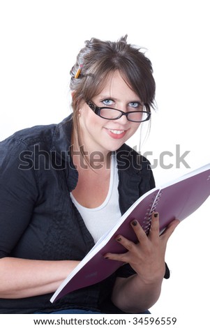 Young  woman looks up from reading her planner; isolated on a white background.